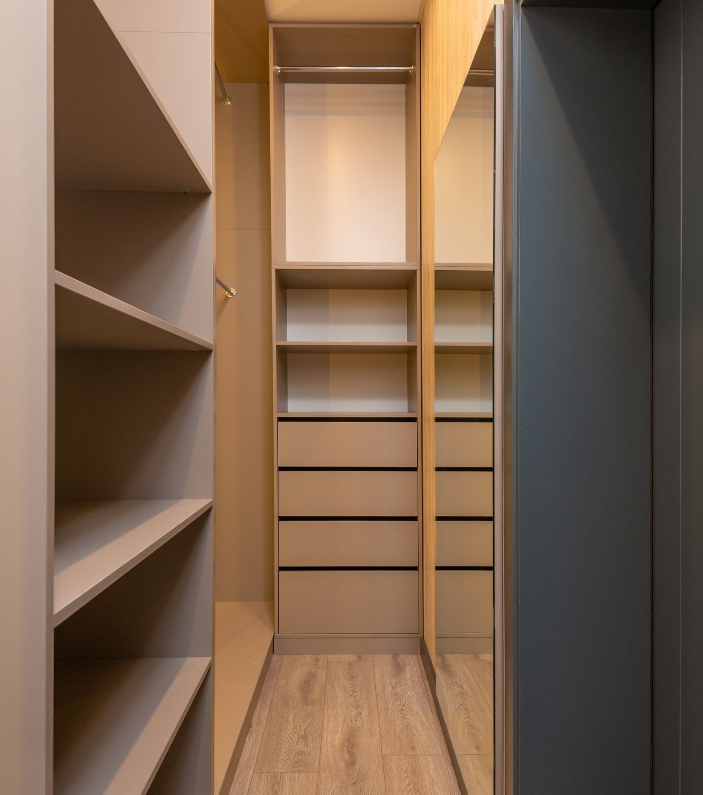Stock inspiration: fitted shelves, drawers and cupboards in a timber-toned dressing area.